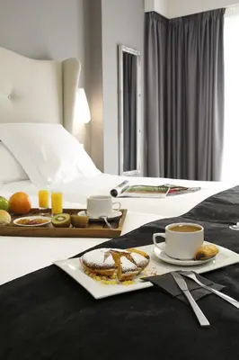 a hotel room with a table with a tray of food at Capitol Boutique Hotel in Santiago de Compostela