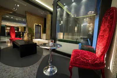 a lobby with red chairs and a table and a room at Capitol Boutique Hotel in Santiago de Compostela