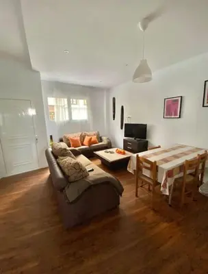 a living room with a couch and a table at PRAD in Foz
