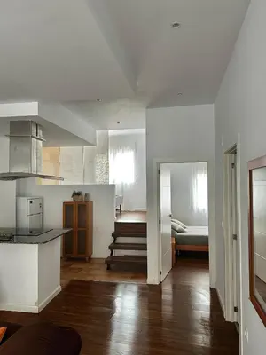 a room with a kitchen and a bedroom with a bed at PRAD in Foz