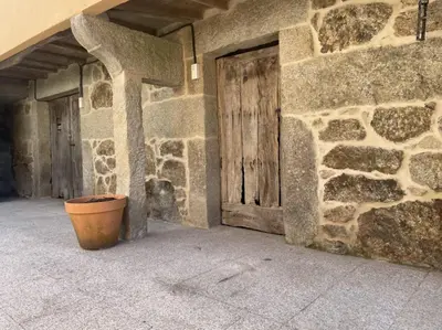 an empty courtyard of a building with a pot at YourHouse A Casa Da Corona casa rural in Parada del Monte