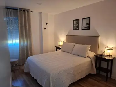 a bedroom with a white bed and a window at Areal in Beade
