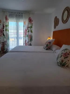 a bedroom with a large white bed and a window at Areal in Beade