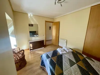 a bedroom with a bed and a fireplace at Casa rural Herminia in Ourense