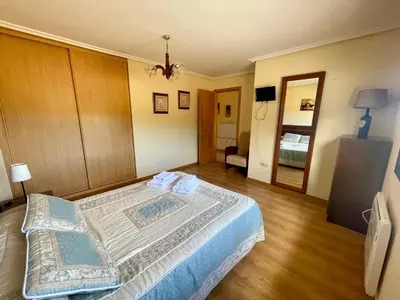 a bedroom with a large bed in a room at Casa rural Herminia in Ourense