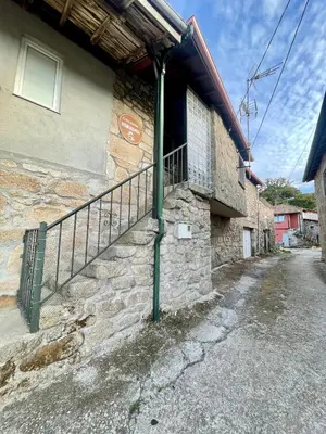 a stone building with a balcony on the side of it at Casa rural Herminia in Ourense
