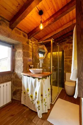 a bathroom with a sink and a glass shower at Casa pepe in Nogueira de Ramuin