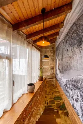 a bathroom with a stone wall and a bath tub at Casa pepe in Nogueira de Ramuin