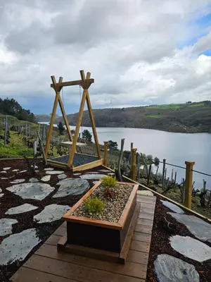 a wooden altar with a cross in front of a lake at Viña Candaz By Oktheway in Taboada