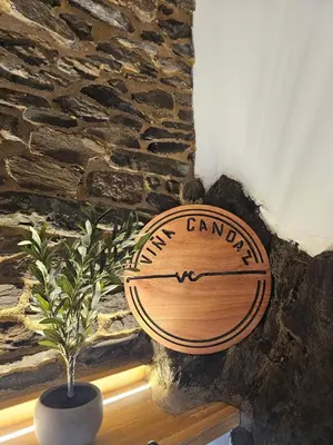 a wooden sign on a stone wall with a plant at Viña Candaz By Oktheway in Taboada