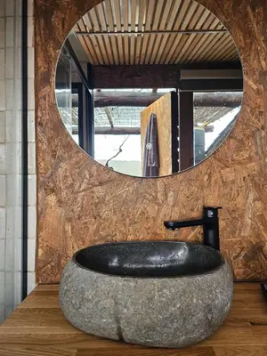 a bathroom with a large rock sink in front of a mirror at Viña Candaz By Oktheway in Taboada