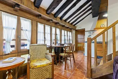 a dining room with a table and chairs at Apartamentos rurales Casa Xepo in Rengos