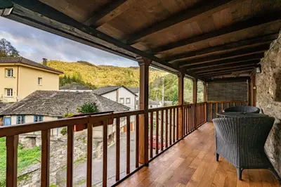 a balcony with a view of a house at Apartamentos rurales Casa Xepo in Rengos