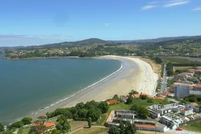 an aerial view of a beach and the ocean at El Pedregal - Playa de Miño in Miño
