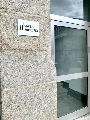 a sign on the side of a building at casa ribeiro in Ribadavia
