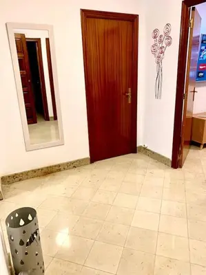 a room with a door and a mirror and a chair at casa ribeiro in Ribadavia