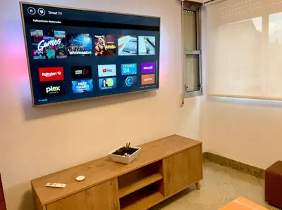 a living room with a flat screen tv on a wall at casa ribeiro in Ribadavia