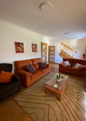 a living room with two couches and a coffee table at Casa do Aloumiño in Portomarin