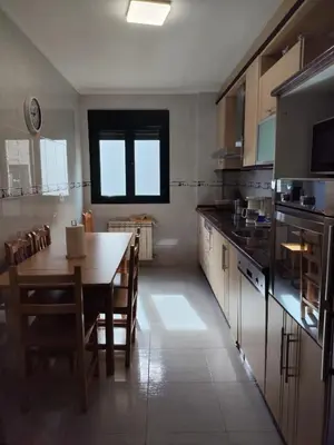 a kitchen with a table and a dining room at Casa do Aloumiño in Portomarin