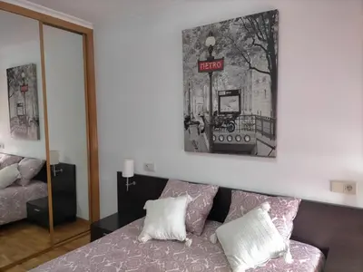 a bedroom with a bed and a sign on the wall at EnFOZ Las Catedrales: Playa, Piscina y Parking in Foz