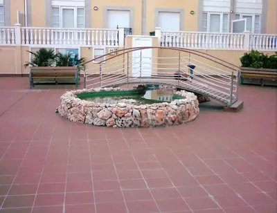 a spiral staircase in a building with a fountain at EnFOZ Las Catedrales: Playa, Piscina y Parking in Foz