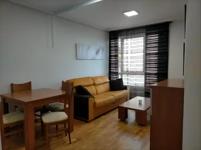 a living room with a couch and a table at EnFOZ Las Catedrales: Playa, Piscina y Parking in Foz