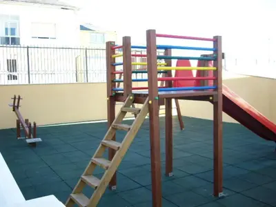 a playground with a slide and a ladder at EnFOZ Las Catedrales: Playa, Piscina y Parking in Foz