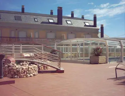 a building with a pen and a building with a building at EnFOZ Las Catedrales: Playa, Piscina y Parking in Foz