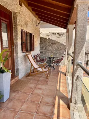 a patio with chairs and a table on a building at Casa María da Reza in Ribadavia