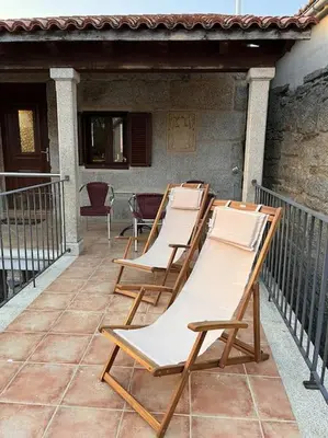 a row of lounge chairs sitting on a balcony at Casa María da Reza in Ribadavia