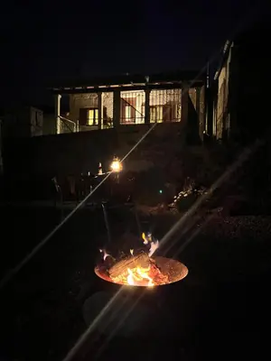 a fire pit in the middle of a yard at night at Casa María da Reza in Ribadavia