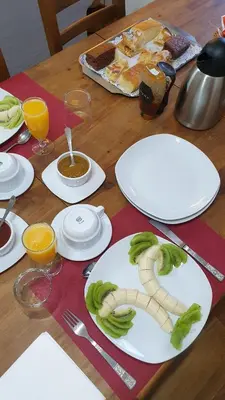 a wooden table with plates of food with a snake on them at Habitaciones - La Pumarada de Limés I in Cangas del Narcea