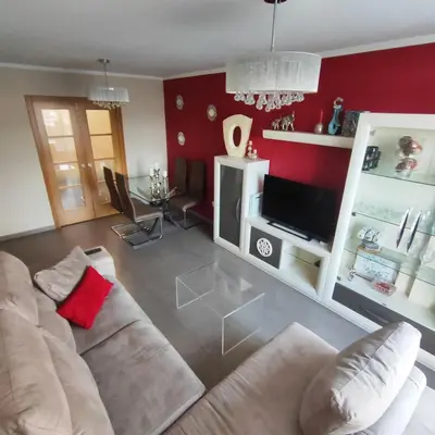 a living room with a couch and a tv at Piso céntrico en Viveiro con aparcamiento in Viveiro
