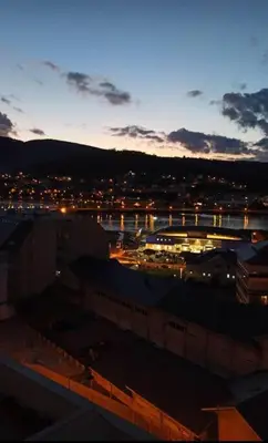 a view of a city at night with a bridge at Piso céntrico en Viveiro con aparcamiento in Viveiro