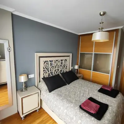 a bedroom with a bed with two pillows on it at Piso céntrico en Viveiro con aparcamiento in Viveiro