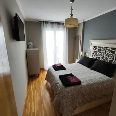 a bedroom with a bed with two pillows on it at Piso céntrico en Viveiro con aparcamiento in Viveiro