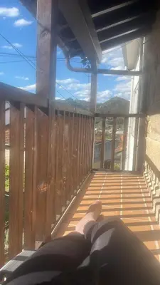 a person laying on a balcony with a view at A MIÑA CASIÑA -TERMAS OURENSE in Ourense