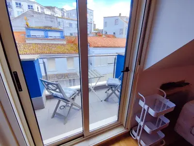 a view of a balcony with chairs and a window at Vivienda Novo Betanzos in Betanzos