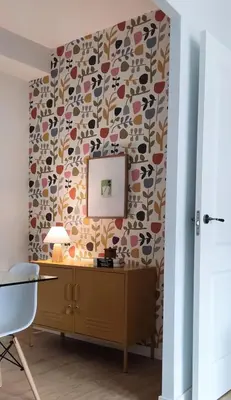a room with a dresser and a wallpaper with a mirror at Apartamento Arcoiris in Betanzos