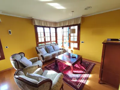 a living room with couches and a coffee table at Casa de campo en Ribadeo in Ribadeo