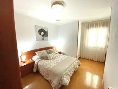 a bedroom with a bed and a window at Apartamento Rivela in Burela de Cabo