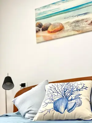 a bedroom with a bed with a painting on the wall at Apartamento Rivela in Burela de Cabo