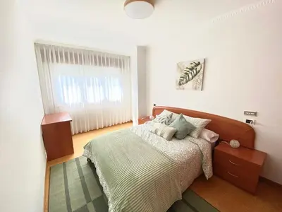 a bedroom with a bed and a window at Apartamento Rivela in Burela de Cabo