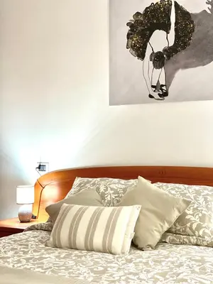 a bedroom with a bed with a picture on the wall at Apartamento Rivela in Burela de Cabo