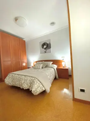 a bedroom with a bed and a large mirror at Apartamento Rivela in Burela de Cabo