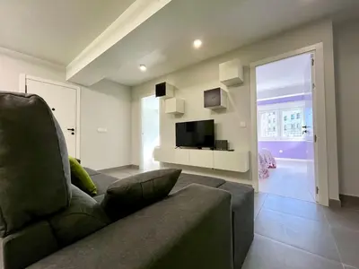 a living room with a couch and a television at Romero AP in Santiago de Compostela
