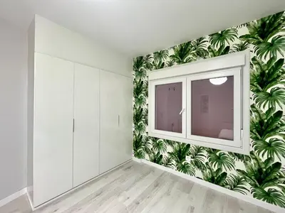 a room with a wall mural of palm trees at Romero AP in Santiago de Compostela
