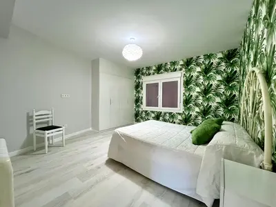 a bedroom with a bed with a green plant wall at Romero AP in Santiago de Compostela