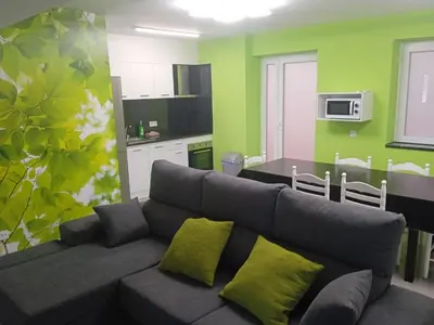 a living room with a couch and a kitchen at Romero AP in Santiago de Compostela