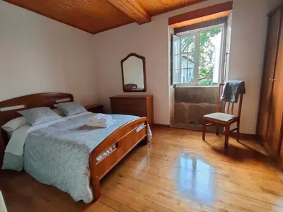 a bedroom with a bed and a mirror and a window at Casa Telmo in Acova